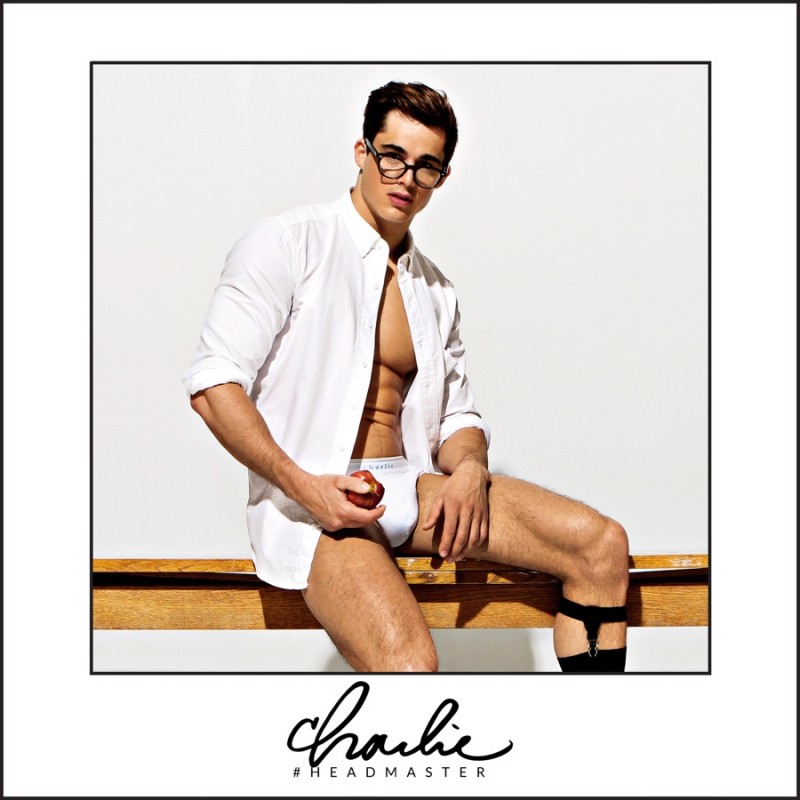Pietro sports glasses and a crisp white shirt for Charlie's latest underwear campaign.