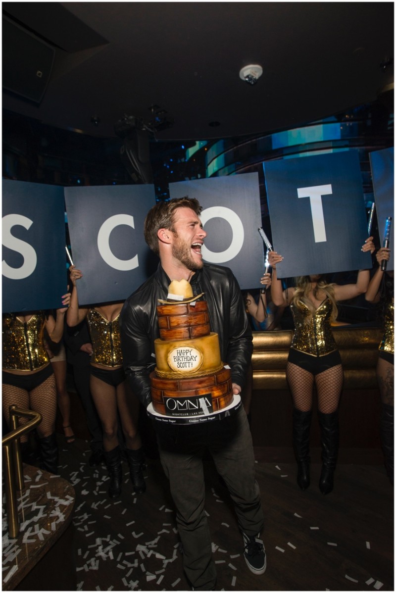 Scott Eastwood is all smiles as he's presented with a three-tier birthday cake.