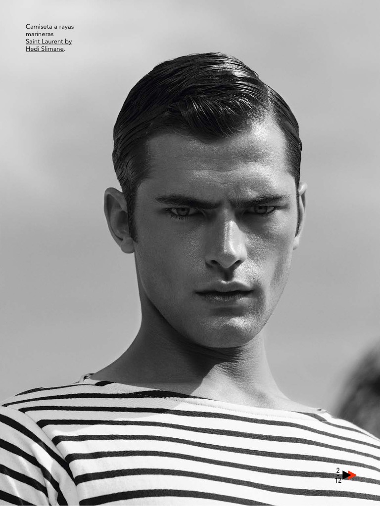 Sean O'Pry poses for a black & white image in a striped top from Saint Laurent.