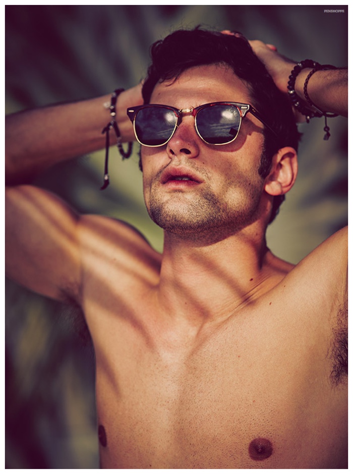 Sean O'Pry soaks in the sun's rays as he relaxes in stylish shades.