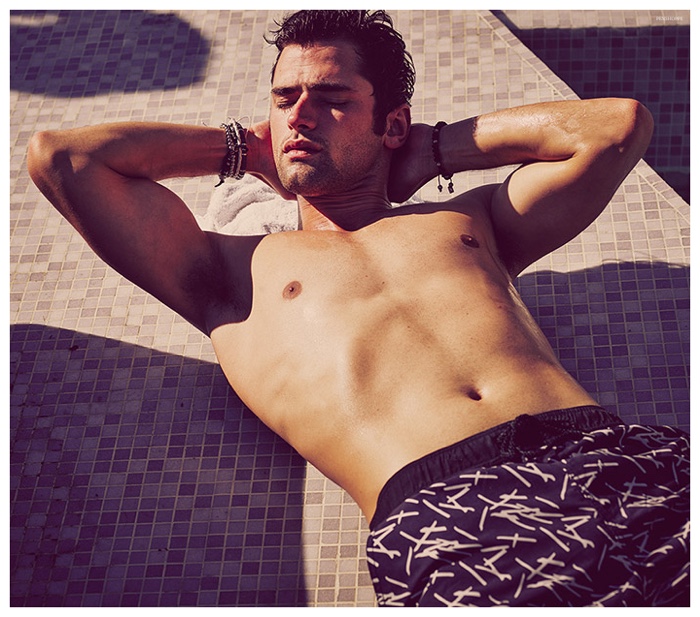 A shirtless Sean O'Pry lays out for a tan.