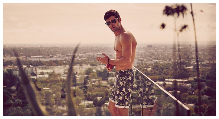 Sean O'Pry overlooks Los Angeles as he lounges in swim shorts.