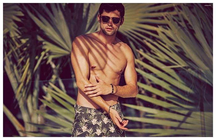 Sean O'Pry is photographed in sunglasses and swim shorts for Penshoppe's summer 2015 campaign.