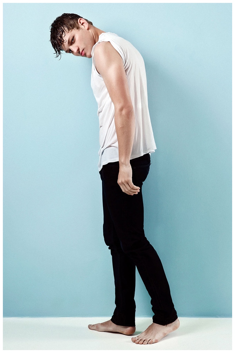 Sebastian Sauve models lean black denim jeans with a slouchy white top.