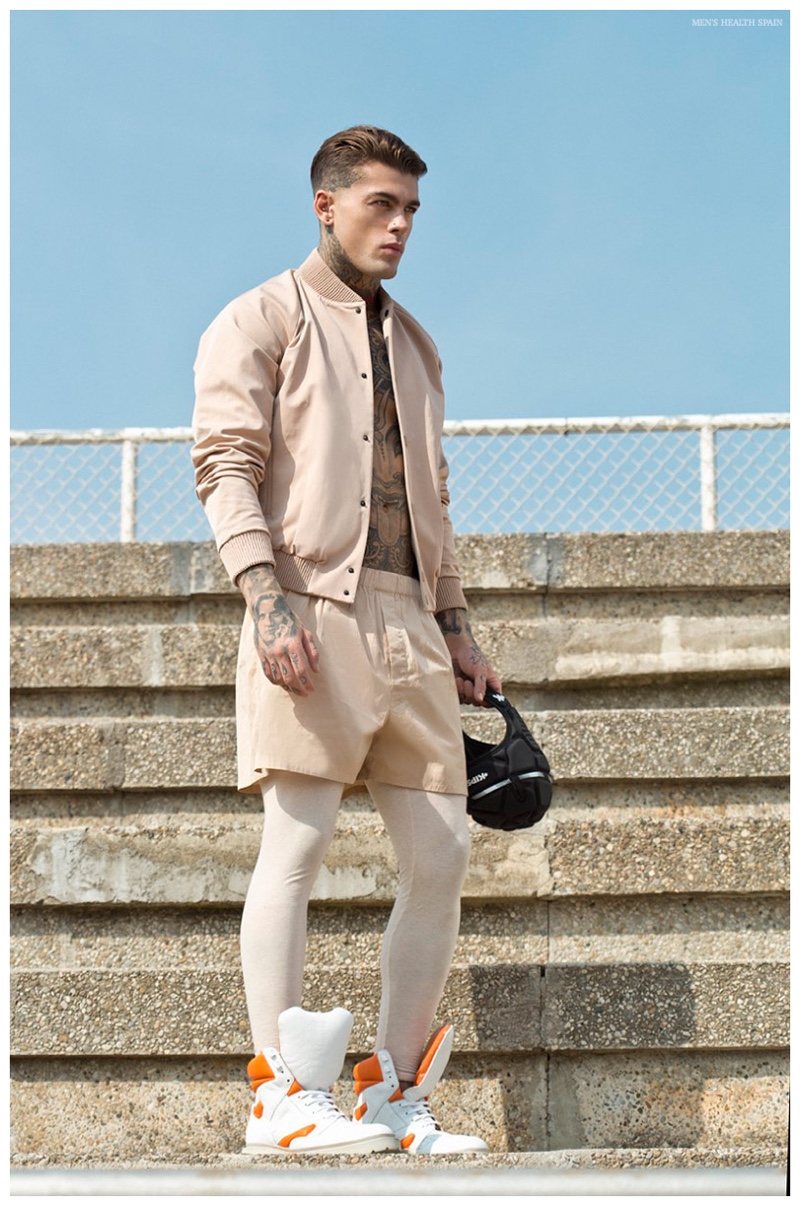 Stephen James embraces a nude color palette in a bomber jacket with matching shorts.