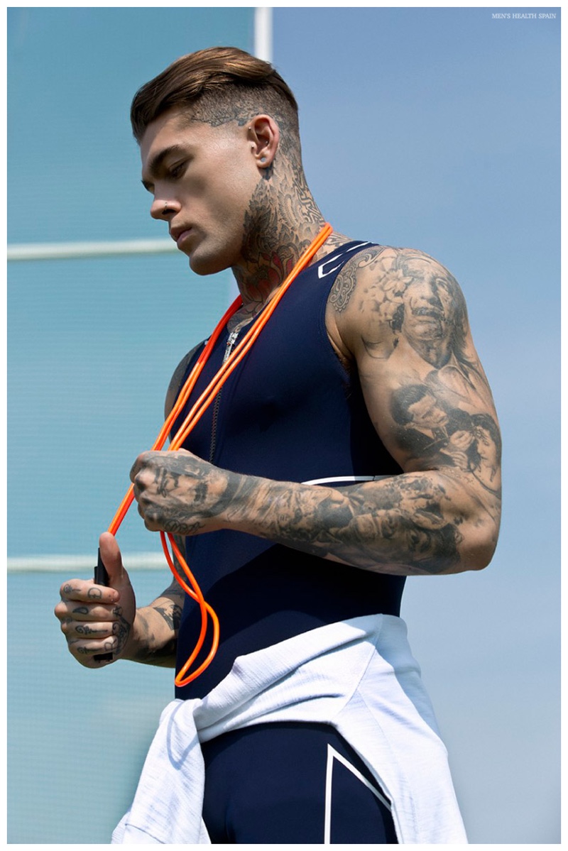 Stephen James puts his tattoo sleeve on display as he poses for a contemplative photo.