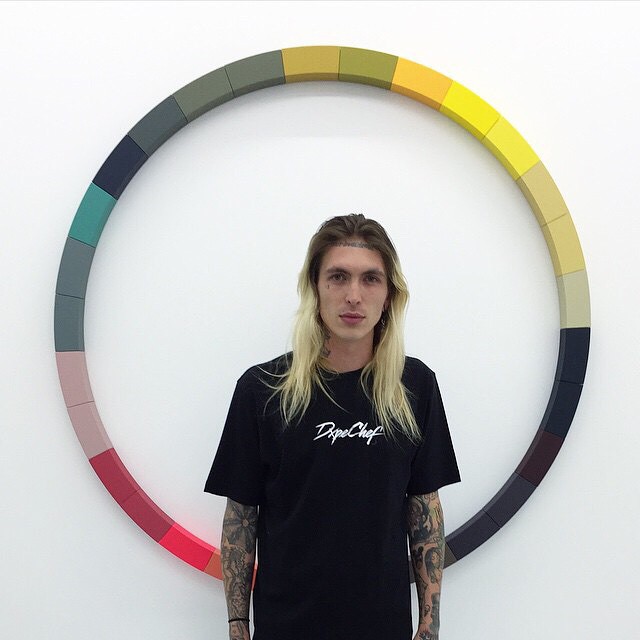 Bradley Soileau sports long bleached blond hair with dark roots.