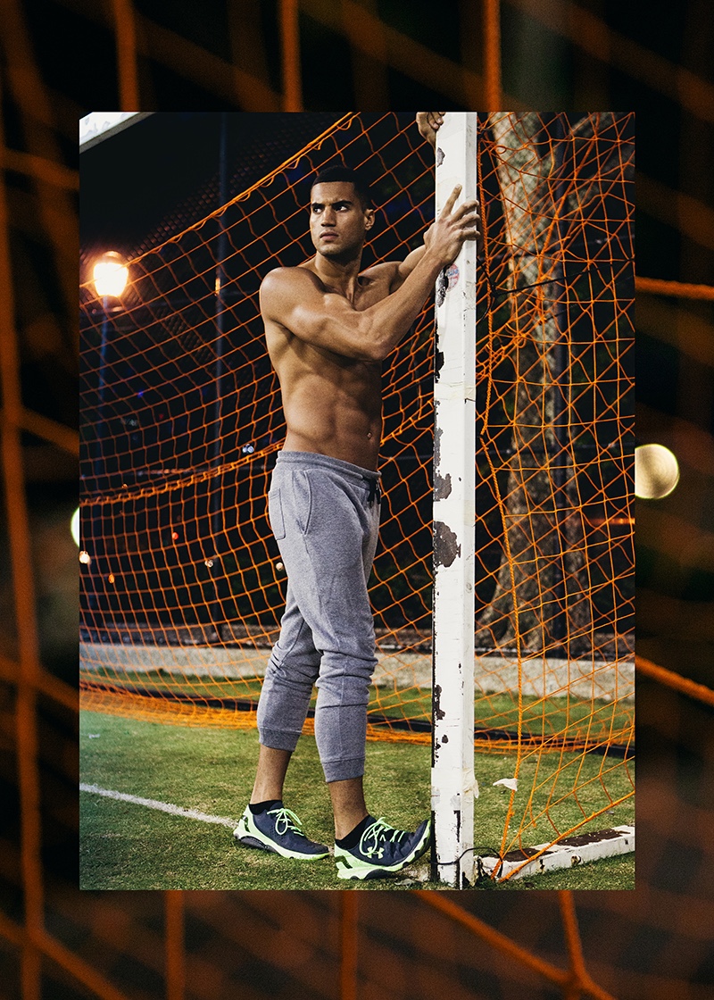 Sporting trendy joggers, Devin poses against a goal post.