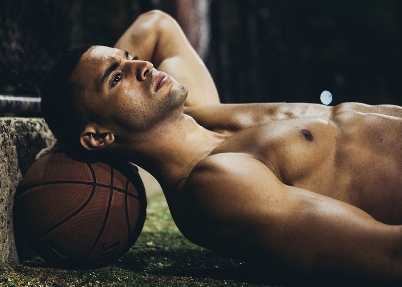 Devin delivers a profile shot as he rests on a basketball.