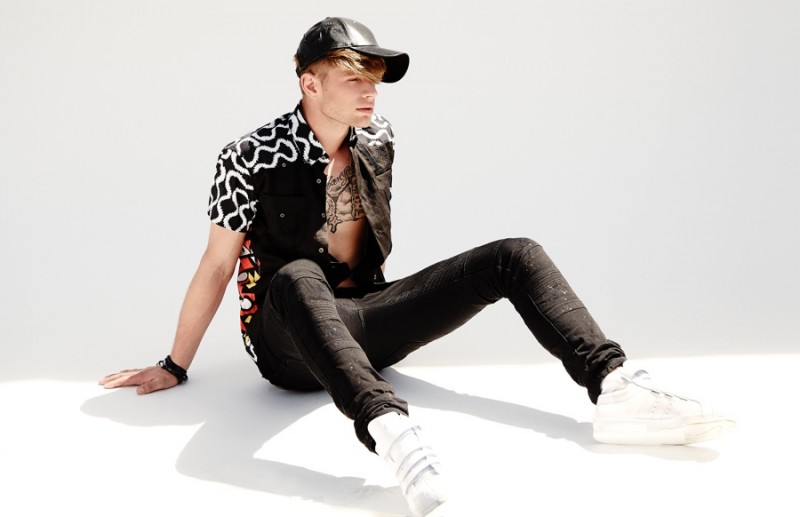 Cody wears shirt Mr Nieves, black jeans Diesel, leather cap Marc by Marc Jacobs and white hi-top sneakers Adidas.
