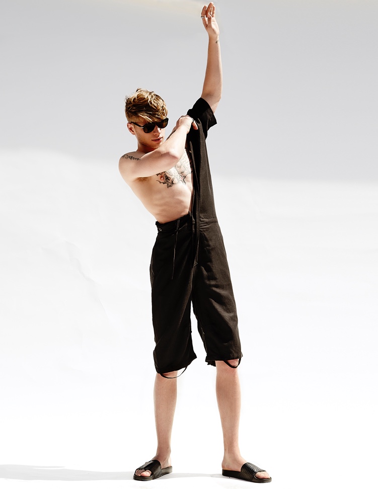 Cody wears jumpsuit Chapter and sandals Raf Simons for Adidas.
