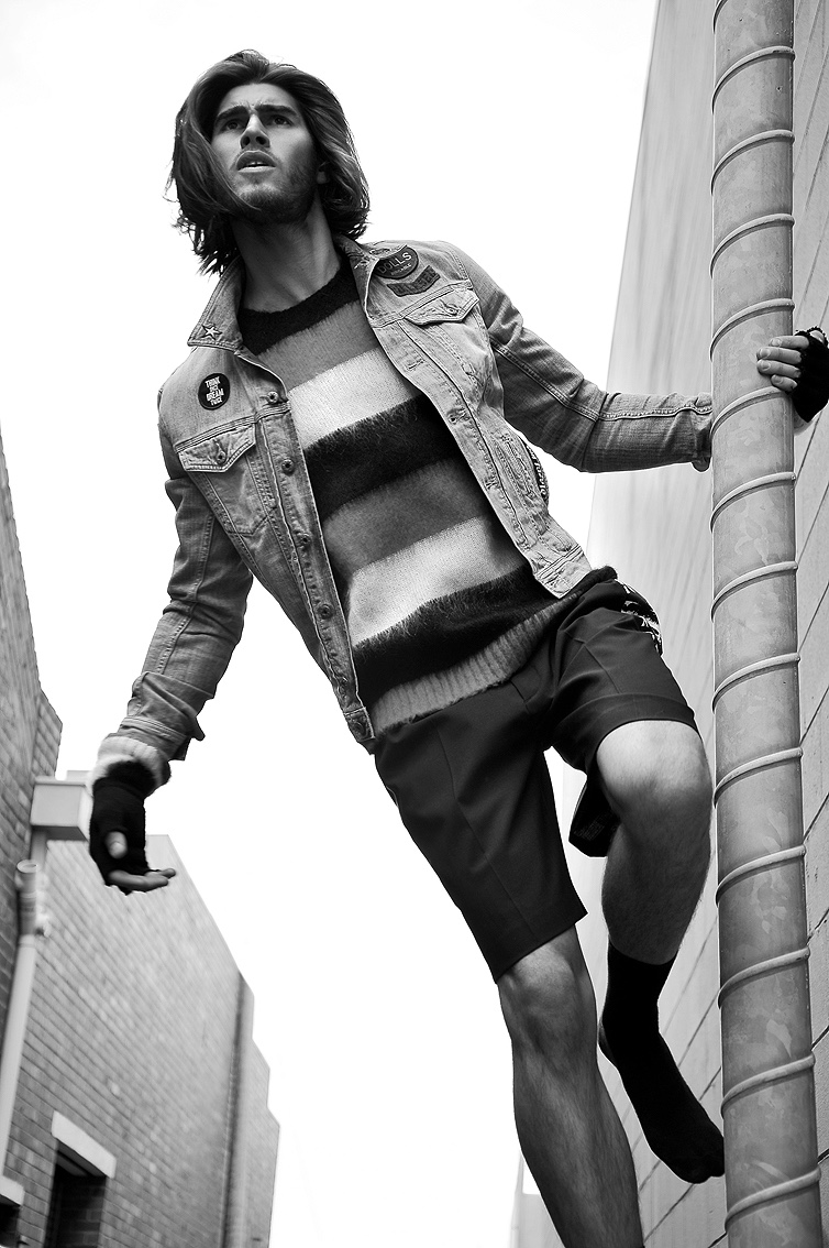 Justin wears shorts Alexander McQueen, denim jacket and striped jumper Diesel.