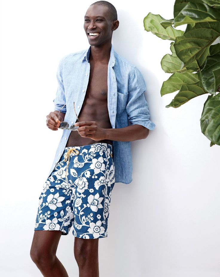 Armando is ready for summer in a pair of tropical print swim shorts.