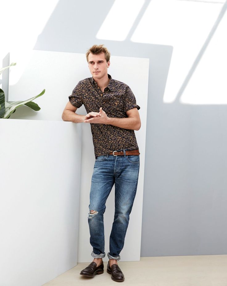 Clément models a pair of J.Crew's distressed denim jeans with a printed shirt.