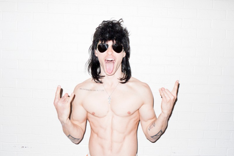 Jared Leto poses in a black wig and sunglasses.