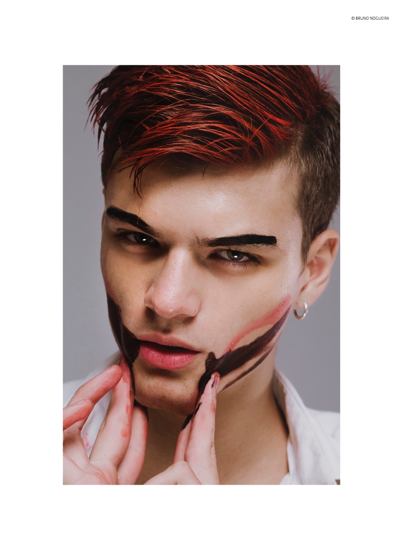 Juan embraces a rebellious edge with red streaked hair.