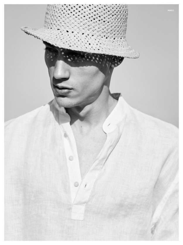 Nicolas blocks the sun with a chic straw hat.