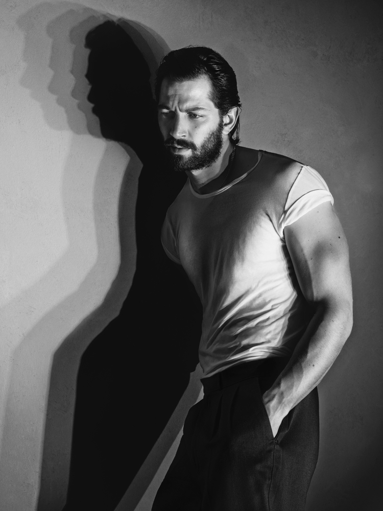 Michiel Huisman poses for a black & white photo in an Acne Studios tee.