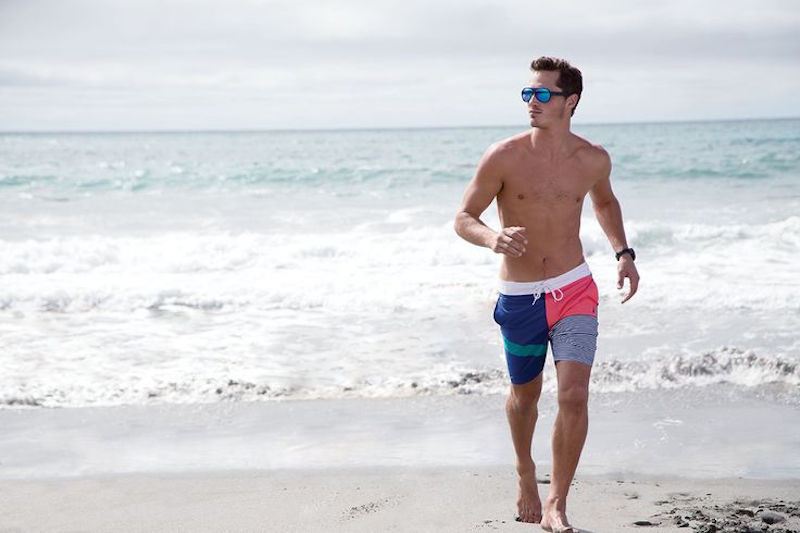 Ollie hits the beach in colorful Nautica trunks.