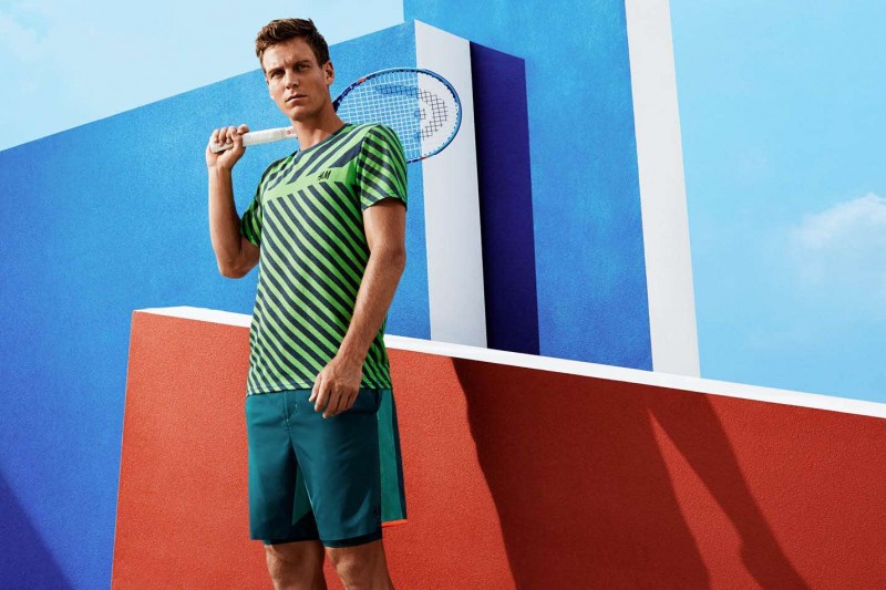 Posing with his tennis racket, Tomas Berdych wears a fun striped tee with tennis shorts.