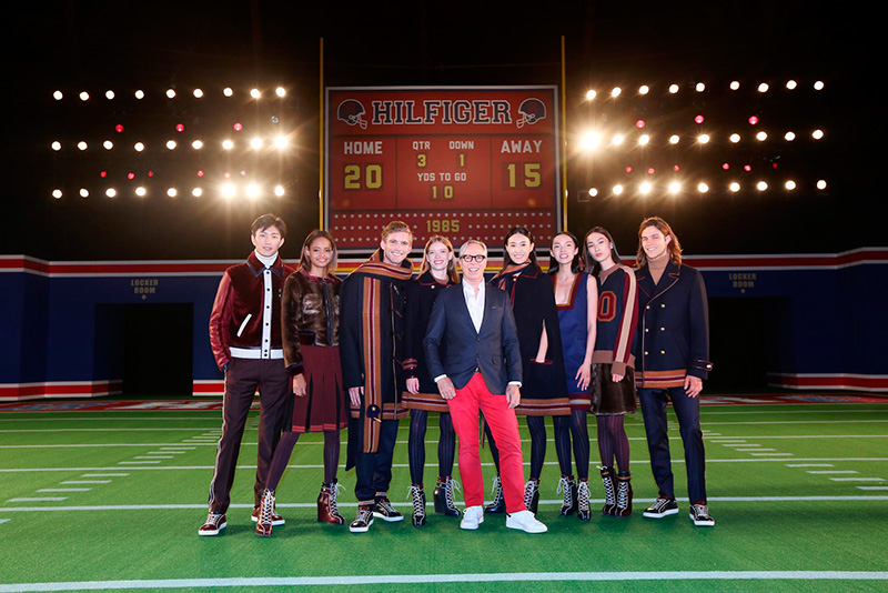 Tommy Hilfiger poses with models showcasing the brand's fall-winter 2015 collection.