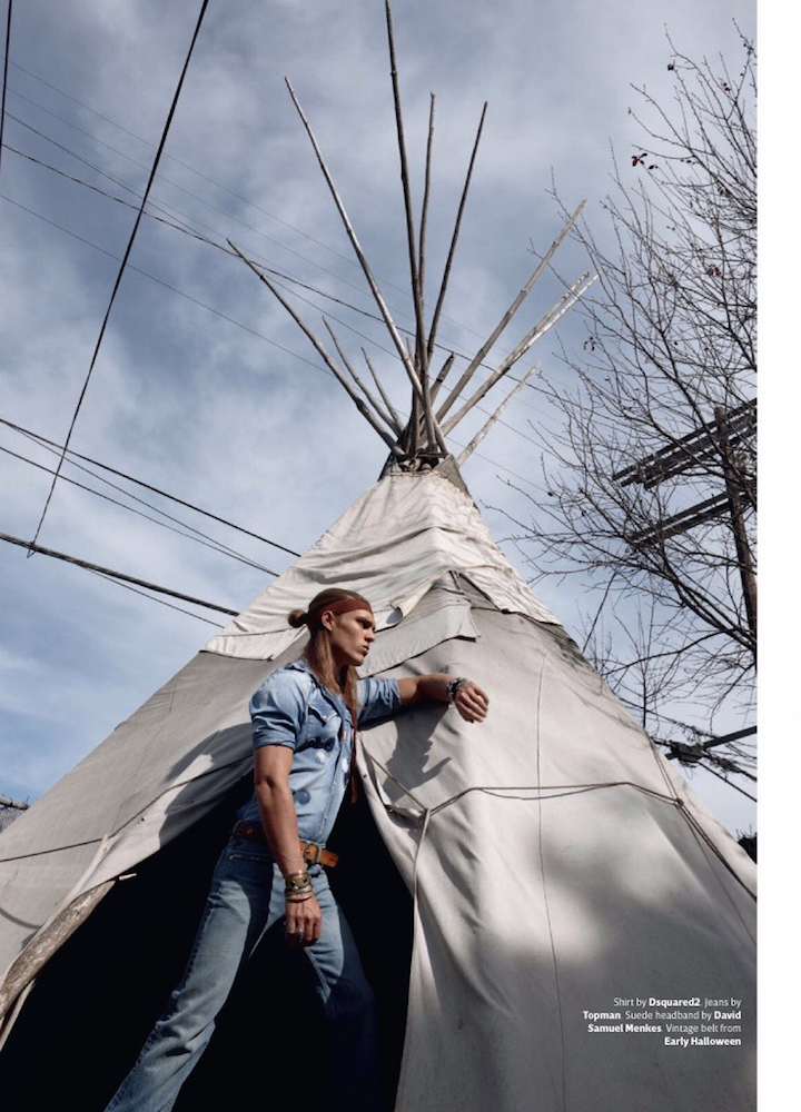 Clad in denim, Travis is photographed outdoors.