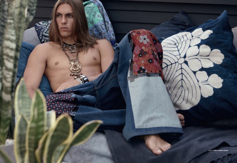 Travis layers on the jewelry as he poses in Marc by Marc Jacobs flared jeans.
