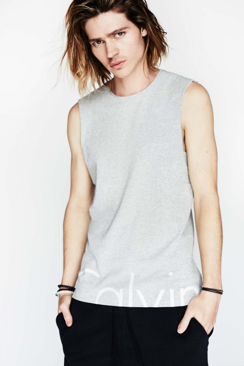 Will Peltz models a Calvin Klein Jeans logo sleeveless tee.