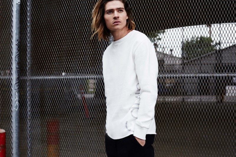 Will Peltz models a Calvin Klein Jeans logo pullover.