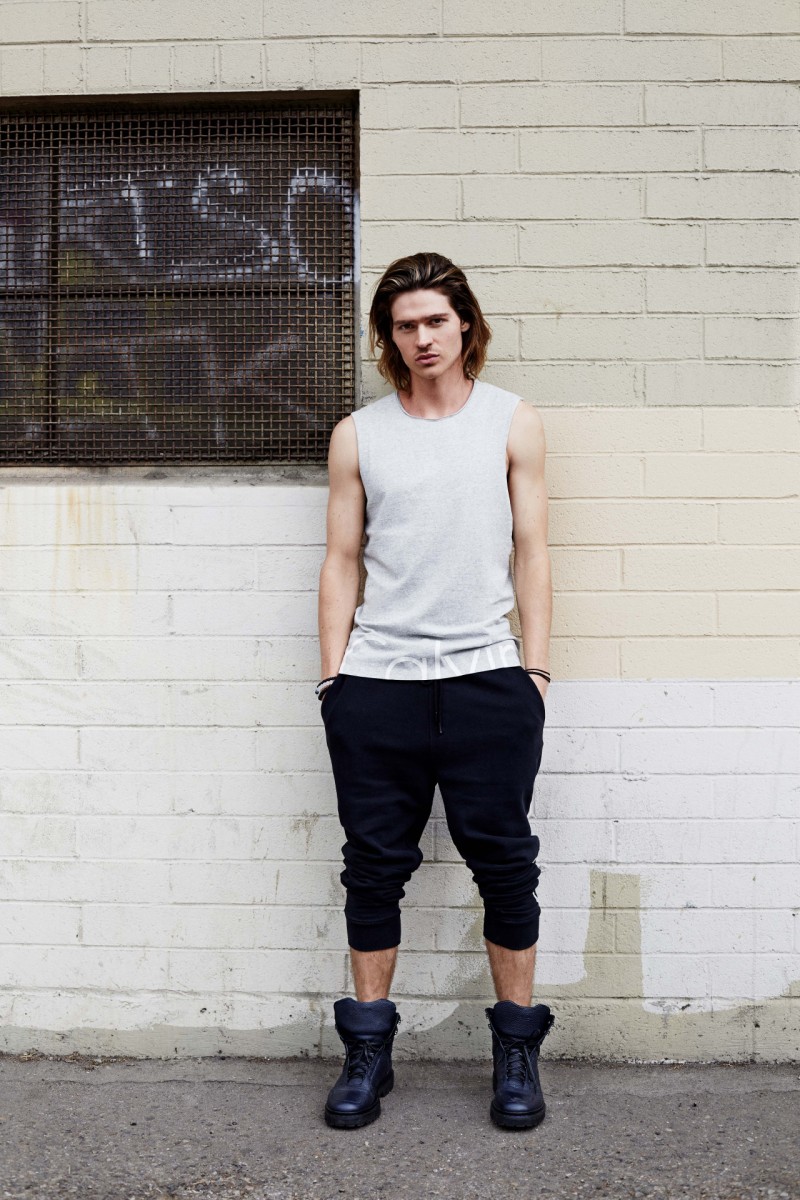 Will Peltz models Calvin Klein Jeans joggers with a sleeveless top.