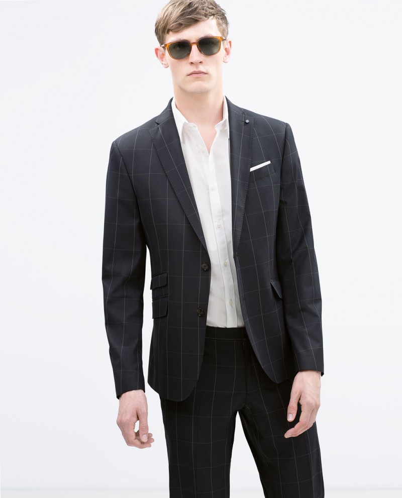 Rutger keeps his cool in a windowpane print suit with modern sunglasses.