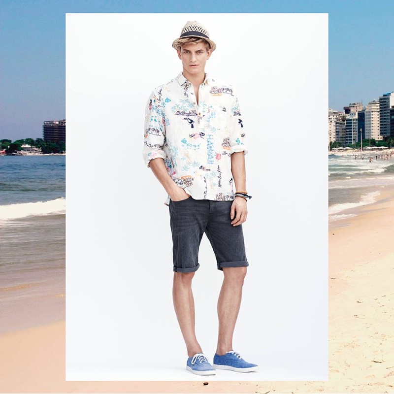 Relaxed denim shorts and a tropical print shirt are on trend for summer