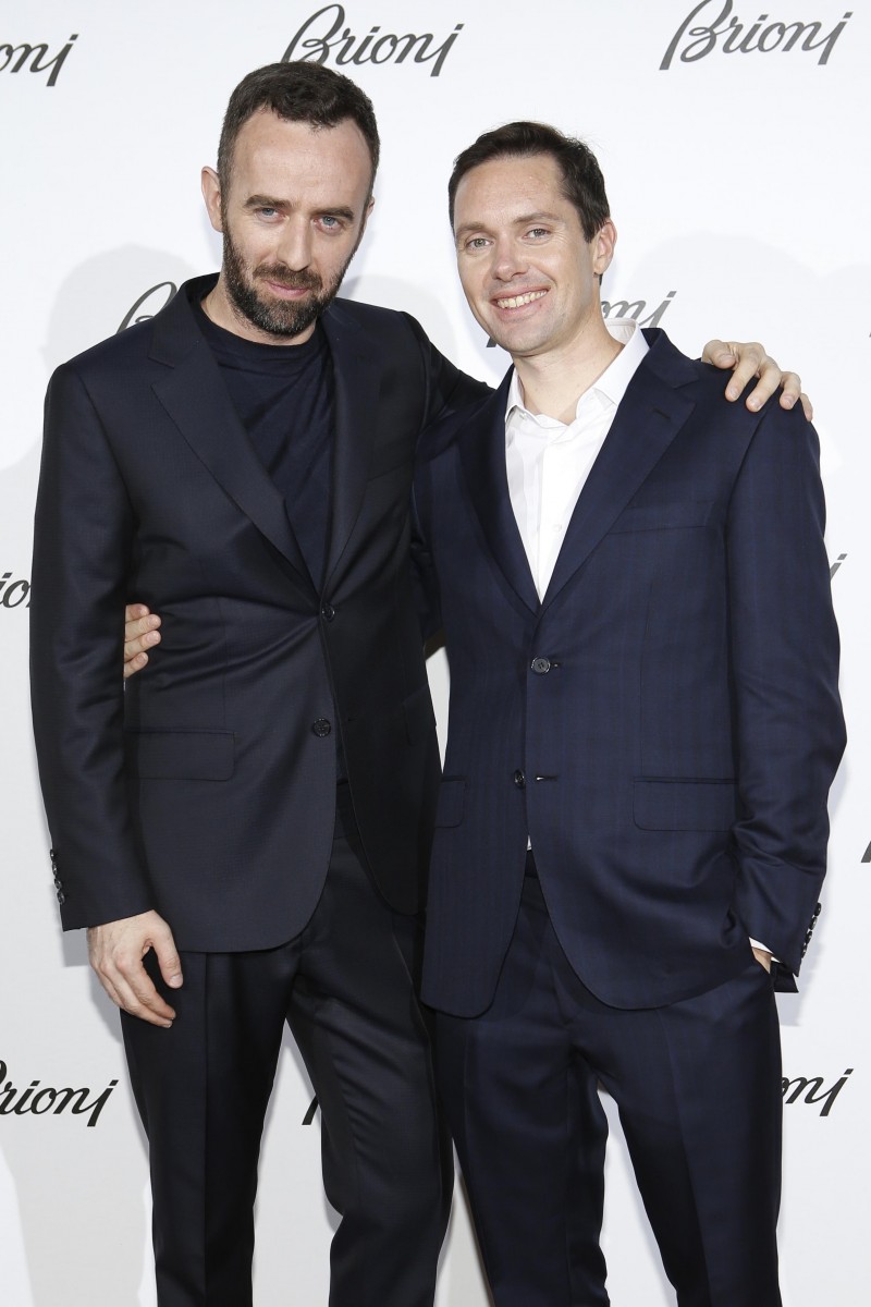 Miles Nikolas Milosh poses for a photo with Brioni creative director Brendan Mullane.