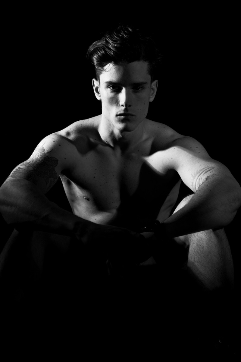 Diego Barrueco poses for a moody black & white portrait.