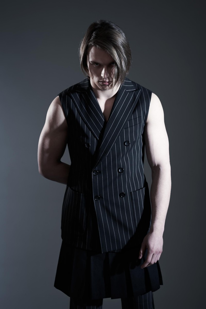 Johannes wears vintage skirt Archivi Mazzini, sleeveless jacket and trousers Hydrogen.