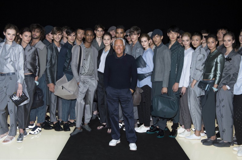 Designer Giorgio Armani poses for a photo with the models who walked the spring-summer 2016 show of Emporio Armani.