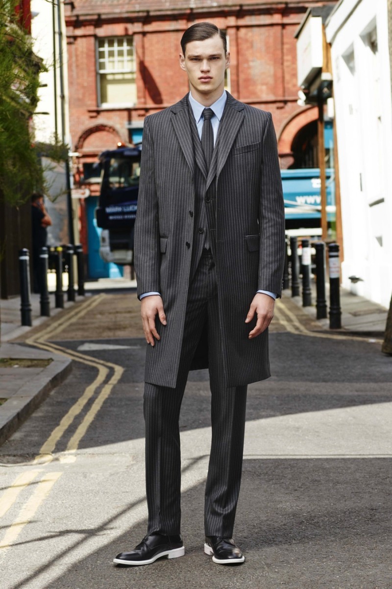 Model Filip Hrivnak models a pinstriped suit from Givenchy's pre-spring 2016 men's collection.
