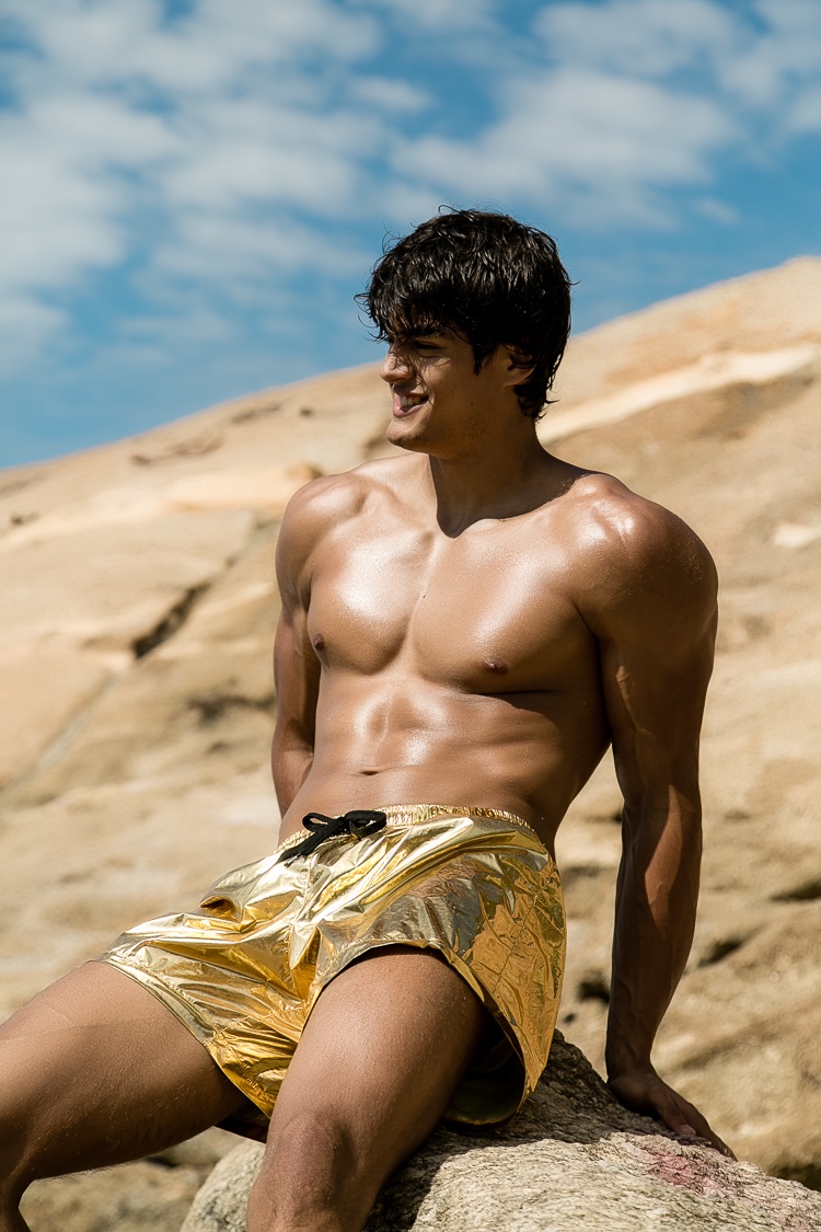 Iago goes bold in gold swim shorts.