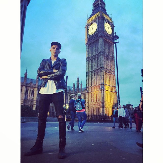 Model Adam Kaszewski takes a photo by Big Ben.