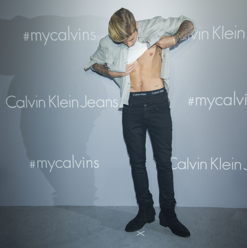 Justin Bieber flashes the waistband of his Calvin Klein underwear.