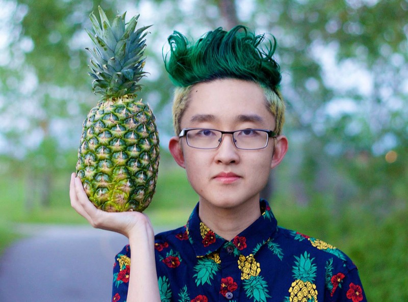 Reddit user Hansel34 poses with a pineapple, showing off his new hairstyle.