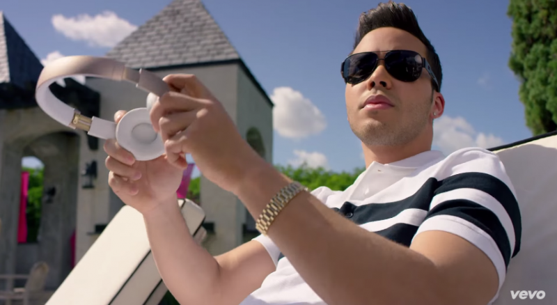 Prince Royce wears Givenchy white and black striped polo. shirt.