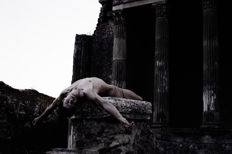 Roberto Bolle poses outdoors for a photo by Fabrizio Ferri.