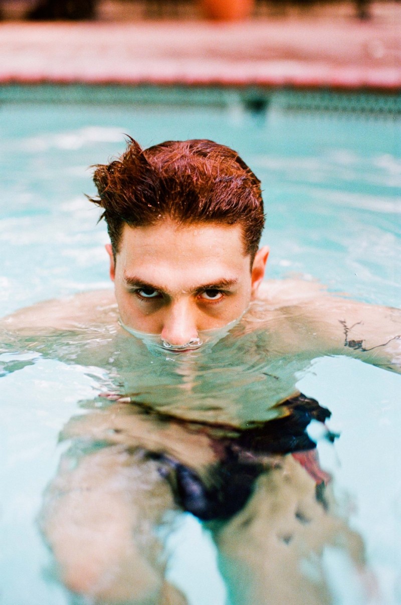 Xavier Dolan goes for a dip in the pool for Assistant cover shoot.