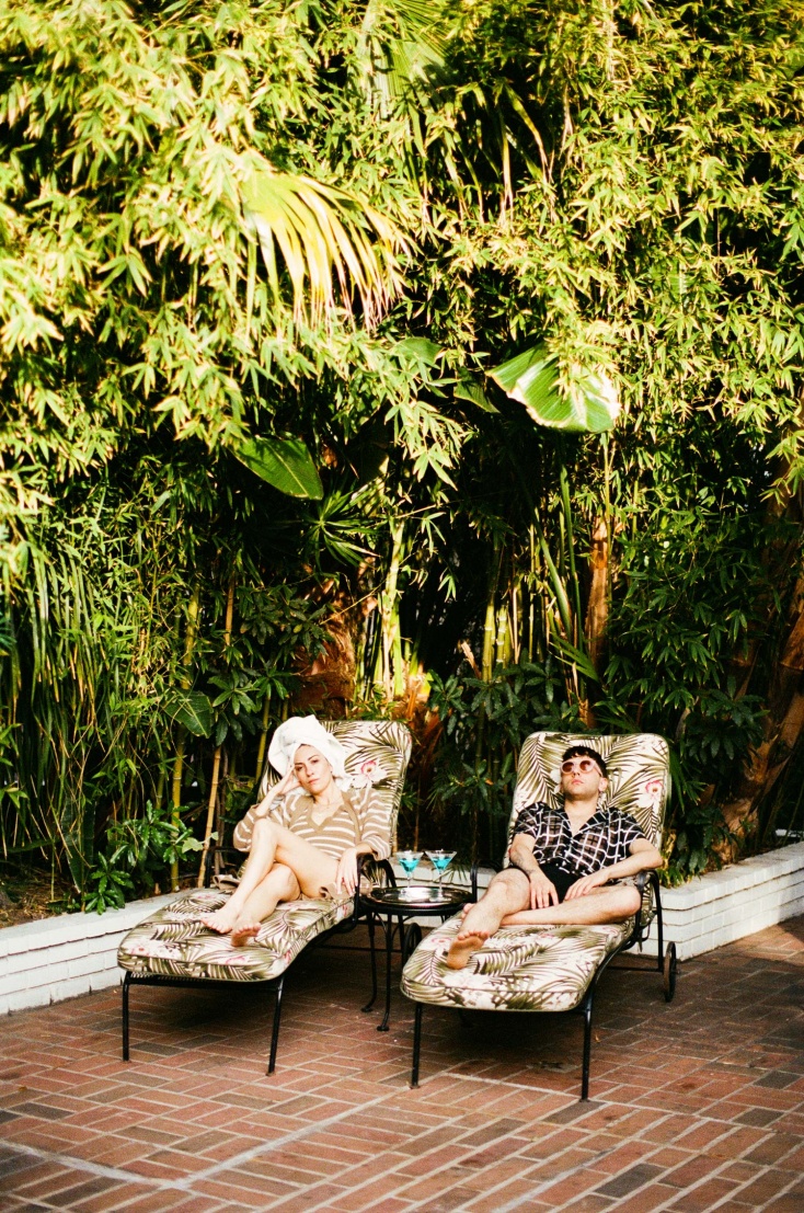 Gia Coppola and Xavier Dolan lounge out by the pool.