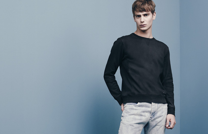 Ben sports a simple pullover with denim jeans.