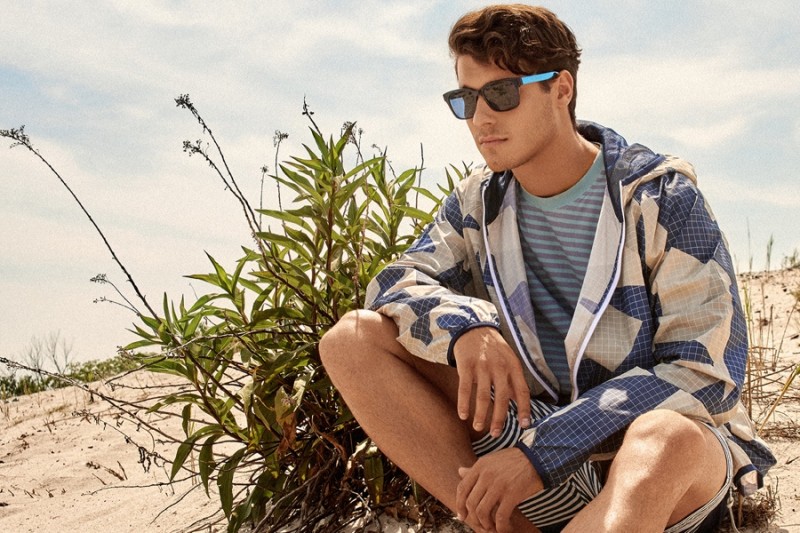 Cody wears t-shirt Paul Smith Jeans, sunglasses stylist's own, shorts Quicksilver and hooded jacket Adidas.