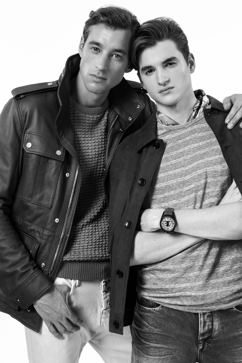 Left to Right: Joel wears leather jacket Bally, jumper Richard James and jeans Calvin Klein Jeans. Peter wears watch Bomberg, denim jeans Calvin Klein Jeans, striped t-shirt and silk scarf Richard James.
