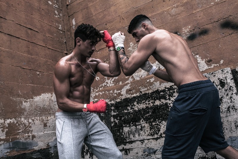 Left to Right: Stefano wears joggers Fanzel Amsterdam, necklace and watch Flüd, bracelet and rings Han Cholo. Evan wears shorts Thing Thing, rings Han Cholo, necklace and watch Flüd.