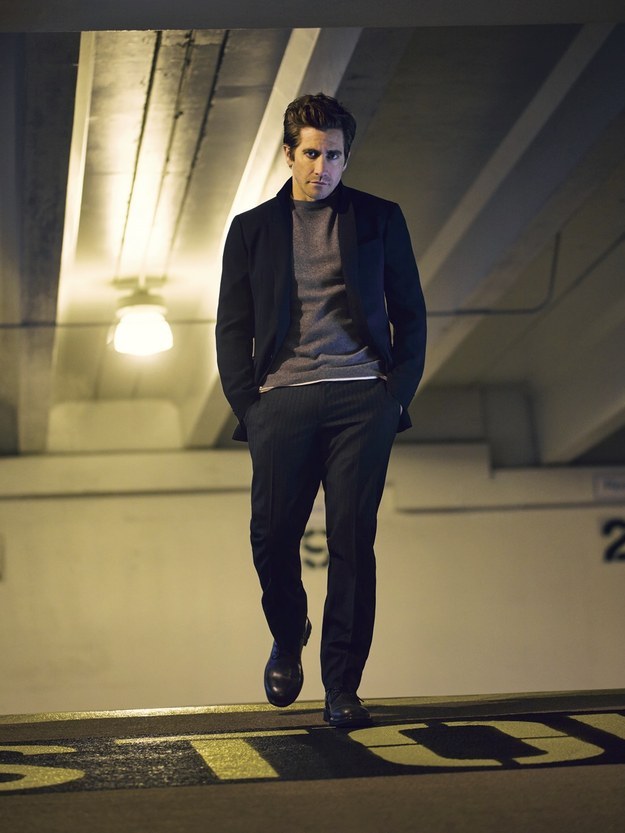 Jake Gyllenhaal poses for a moody image in a parking garage.
